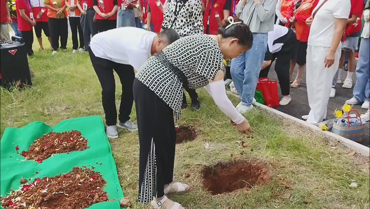 9.家属捧入第一捧土.jpg